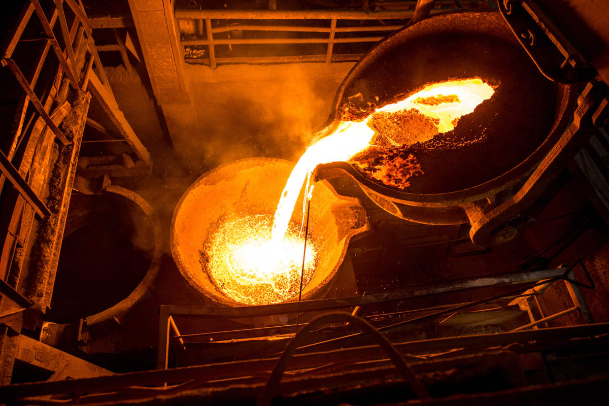 Tank pours liquid metal at the steel mill as a part of slag processing